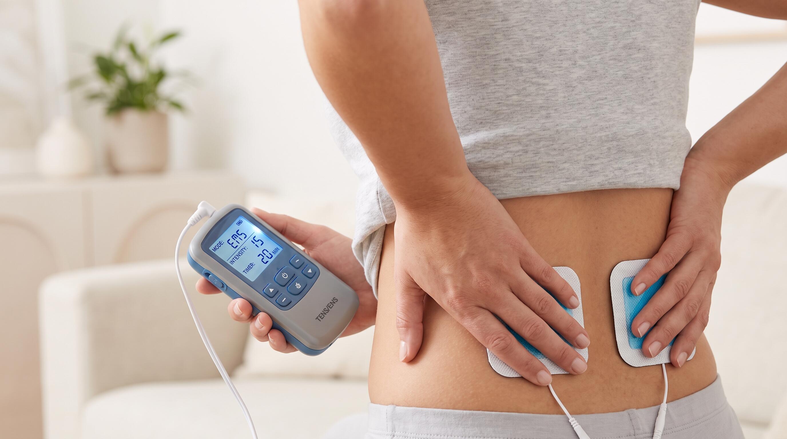 Professional-grade home electrotherapy device in use for muscle stimulation